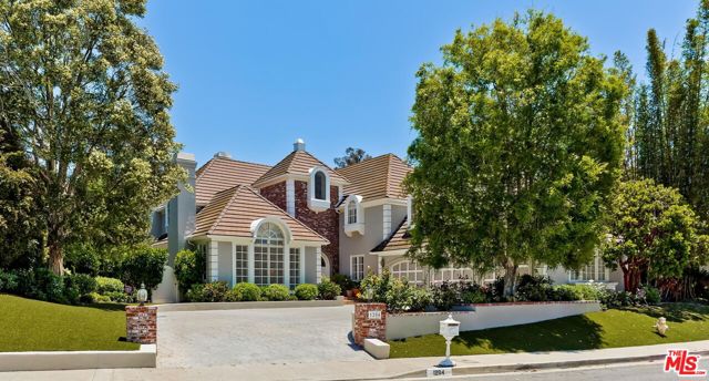Located in the prestigious Palisades Hills area of the Highlands, this gracious 4 bedroom, 4  bath home has a European influence while exemplifying many elements of the California lifestyle.  As you walk through the arched front doors with stained glass windows into the two story entry hall with gleaming wood floors, you immediately appreciate this light-filled home with exquisite details. The living room, family room and dining room all open onto the entry hall, effortlessly embracing a traditional yet open floorplan. The elegant living room has a cathedral ceiling, arched windows with plantation shutters and a beautiful fireplace. The large formal dining room with a coved ceiling and wood floors is perfect for a dinner party and the inviting family room with a fireplace, wet bar and alcove with bay windows is great for relaxing.  A well equipped kitchen with built-in stainless steel appliances, granite counter tops and a center island with a sink is ideal for someone who loves to cook. There is a large breakfast area with bay windows, built in desk and  beautiful cabinets.  The adjacent laundry room has additional built in cabinets offering expansive storage. The main level also has a powder room and a bedroom with its own bathroom. Upstairs, you will find an open center hall area with a built-in desk and cabinets. The spacious primary suite, which is located privately on one side of the hallway, has a double door entry, arched windows with plantation shutters and a fireplace.  There is an alcove with bay  windows on one side of the bedroom that is a lovely place to start your day gazing out at the serene canyon views. The primary bathroom has a luxurious spa tub, a large glass enclosed shower with built in seat and double sinks with a vanity. An expansive walk in closet completes this beautiful primary suite. On the other side of the hall there are two additional bedrooms and bathrooms as well as a home office that could be converted to an additional bedroom if desired. This meticulously maintained home lends itself to entertaining indoors or outdoors with the newly updated landscaping and the lovely inviting deck overlooking the beautiful canyon vistas. The effortless indoor-outdoor flow from the family room, dining room and kitchen allows for a wide range of possibilities - elegant dinner parties, al fresco dining or an informal gathering with family and friends.  Conveniently located near the Palisades Hills Homeowners Association pool, spa, tennis courts and clubhouse, this property presents a unique opportunity to enjoy all the Highlands has to offer while still being  close to the beach and village.