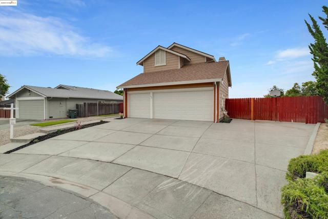 View of property exterior featuring roof with shingles, concrete driveway, and brick siding