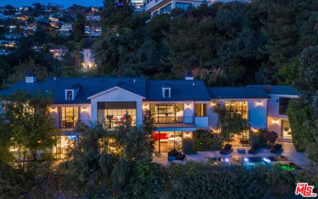 1500 Forest Knoll Drive Los Angeles, California On Forest Knoll, one of the most coveted streets in the Sunset Strip. Private gated celebrity compound with large motor court and a long private driveway leading to a newly completed modern farmhouse by LAs hottest interior designer, Karan Brady. Every inch of this dream estate is crafted with the finest details and perfect for entertaining on any scale: Belgium oak floors and beam ceilings, chefs kitchens with all the latest and greatest amenities, gorgeous entrance waterfall, state-of-the-art game & media rooms and full gym. Beyond its Steelcase floor-to-ceiling windows is a crystal garden with infinity pool/spa that spills off the edge of the city. Primary suite with vaulted ceilings, partners baths and sauna overlooking the explosive views of the entire city. You dont see houses in the Sunset Strip with such sophistication in style. This is a one-of-a-kind dream estate. Come experience it for yourself and live among the worlds most discerning elites.