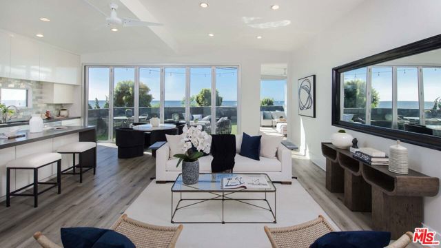 Nearly 2,000SF of modern living in this Pacific Palisades beach home with sweeping ocean-views from Palos Verdes to Malibu. This recently renovated 4 bed, 2 bath residence boasts floor to ceiling windows along two walls and bi-folding doors that open to a private entertainers patio looking out to the sandy beach and crashing waves. This thoughtfully designed bright, cheerful, sun-filled home features vaulted 12' ceilings, open concept living room and kitchen with 10' island, a beautiful ensuite master bath with soaker tub, plenty of storage and three-car side-by-side parking. Minutes to hiking and biking trails, and the Palisades Village with shopping, dining and top-rated schools. The home is uniquely positioned across from Will Rogers Beach just off the Pacific Coast Hwy in an understated up and coming beachside community of the prestigious Pacific Palisades. Community pool and spa. Crosswalk for easy access to beach with volleyball nets, swings, bike boardwalk and surfing. Few homes capture the essence of California living like this Pacific Palisades, ocean-view Beach Bungalow. Land lease of $1,424.50/ month.