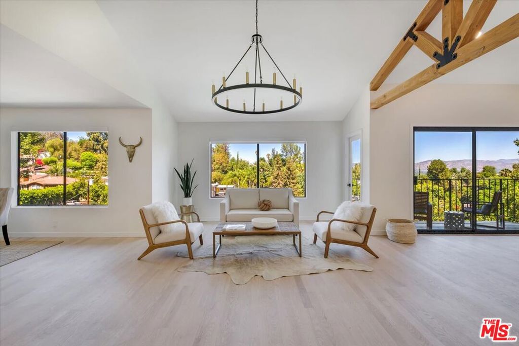 22287 Cass Avenue Woodland Hills, California Stunning newly renovated 4 bedroom, 3.5 Bath with amazing pool, located South of the Blvd. in the prestigious Woodland Hills a few blocks west of Topanga Canyon. This home offers expansive views of the Santa Susanna Mountains from every level and master bedroom. The top story includes a gourmet kitchen, formal living room and dining area with balcony, custom beamed ceilings with exposed wood trusses and working fireplace along with red oak flooring throughout. One floor below, you will find a state of the art theatre room with leather seating, giant screen and projector. In the next room over, you will find a large infrared sauna with built in stereo leading to a private deck made of Trex composite with brand new turf. This floor also has a large full bathroom along with two generously sized bedrooms. The expansive master suite consists of walk in closets, jacuzzi tub and a private balcony with amazing views. The bottom floor has a recreational room and family room with beautiful Saltillo tile floors that continue into a maid's suite and bathroom. Leading out of the lower level, you have a beautiful hardscape patio with a heated pool, spa and waterfall surrounded by a beautiful wall with exquisite landscaping. Come by and see this reimagined oasis, which is truly a one of a kind property today!
