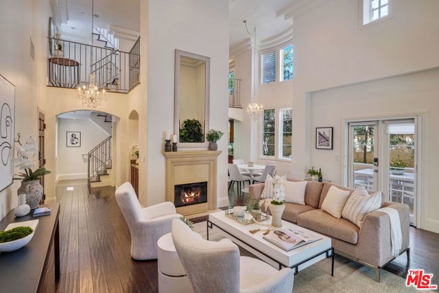 1311 Centinela Avenue 1 Santa Monica, California Located moments from the hub of Santa Monica shopping, dining and beaches, this spacious Mediterranean townhome exudes style and timeless sophistication. The front door opens to a stunning display of soaring double height ceilings flooded by natural light. Voluminous living space is punctuated by clerestory windows and banks of French doors that offer lush tropical greenery views. The living room is warmed by a central fireplace and flanked by two patios for al fresco dining and outdoor living. A thoughtfully outfitted kitchen with granite counters, high-end stainless appliances and walk-in pantry opens to an adjoining dining area, illuminated by a sparkling crystal chandelier. An airy loft overlooks the living area below and affords ample space for multiple uses; home office, studio, media room or gym. Two inviting en suite bedrooms comprise the top floor, including the luxe primary suite with vaulted ceiling, spa bath, walk-in closet and a sunny balcony with treetop views. The lower level features direct access from a private two car garage and a bonus space with extra storage adjacent to a large laundry room. Set in a sumptuous 8-home community minutes from everything you want or need in Santa Monica, this sublime retreat offers the absolute best of modern coastal living.
