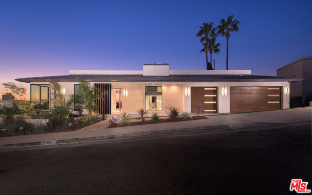 1355 Berea Place Pacific Palisades, California This brand-new contemporary construction is a masterpiece of design offering breathtaking Pacific Ocean views as well as 180-degree panoramic city landscape views. This is truly a unique property with exquisite taste and detail, situated in the prestigious Pacific Palisades neighborhood, just moments away from the Palisades Village. This elegant home boasts six large en-suite bedrooms and seven-and-a-half bathrooms. Enter on the main level to high ceilings, open floor plan and sliding Fleetwood glass doors throughout. The private pool, spa and built-in BBQ is perfect for entertaining. Enjoy the spacious chefs kitchen with top-of-the-line appliances, formal living room and family room. Upstairs features the private master suite with fireplace and balcony with incredible views. The lower lever features a full light up onyx bar, wine cellar and viewing room. Amazing rooftop deck with built-in BBQ and fire pit, 3-car garage and elevator complete this offering.