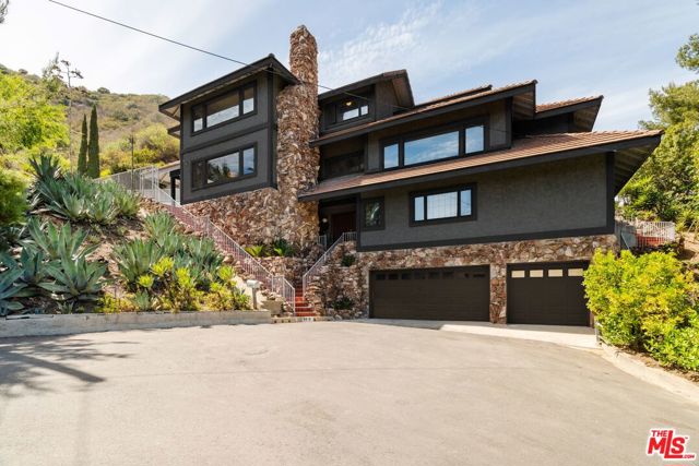 9819 Curwood Place Beverly Hills, California DESIGN OPPORTUNITY! Revel in the possibilities of this spacious hillside cul-de-sac home located on a 1/2 acre lot in BHPO. Enjoy 4 BR/3.5 BA + secluded pool + jacuzzi, and spectacular views all within a private setting. Exterior boasts character stacked rock detailing + ground level 3-car garage w/functional elevator access. At every lvl, experience sunlit rooms, most w/alluring views of the canyon or city. The main floor is perfect for hosting parties, feat. its own entertainment room with/built-in fireplace + bar area that leads out to pool + hot tub, where one can bask in the beauty of the canyon + warmth of the CA sunshine. Spacious kitchen offers tons of storage, a charming breakfast nook + access to patio. Oversized living rooms incl. ample dining rm area for formal dinner parties. Master BR showcases sweeping views of the city + incl private balcony overlooking the pool + hillside. Spa-like master BA has marble details throughout, soaking tub, sep. shower, sauna + private outdoor space, perfect for your morning espresso. Downstairs offers 2 spacious BRs + jack-and-jill BA w/generous laundry rm. Perfect blend of quality construction + opportunity, all thats left is your design vision! Ideally located for peace and quiet, but short distance from the glamour of Rodeo + Sunset. Easy 405 and Valley access, moments to Mulholland. Welcome home!