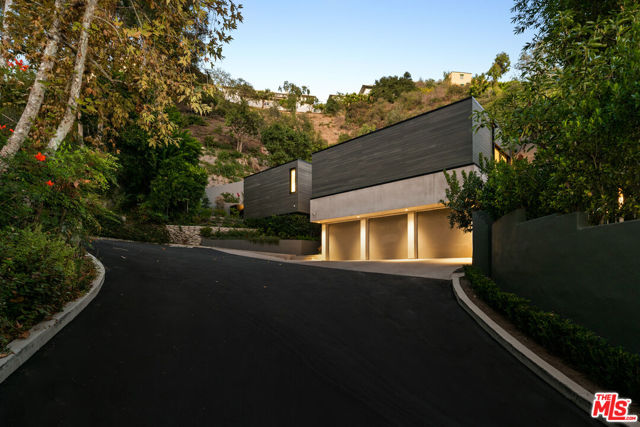 Set on a private cul-de-sac in the exclusive Bel Air neighborhood of Stone Canyon is this one-of-a-kind, meticulously remodeled modern-contemporary home. Exuding opulence throughout, as you enter the 12ft wooden front door you are immersed with 2-story soaring ceilings and floor-to-ceiling windows that radiate bright, natural light in its entirety. The main level includes a family room with fireplace and large windows that open to the canyon and manicured front yard, as well as an expansive gourmet chef's kitchen with custom Italian cabinets, marble waterfall center island and top-of-the-line Miele appliances. From the kitchen, Fleetwood glass doors and windows open to the backyard creating that true indoor/outdoor California living at its finest. Travel up the staircase, illuminated by a large, beautiful skylight that leads to your primary suite, 4 additional bedrooms, and a bonus area. The primary suite emits stunning natural light with radiant floors and has a spa-like bathroom with steam room, Italian dual vanities, Italian marble shower with rainfall showerhead, and a showroom style walk-in closet. From the primary bedroom, cross over the bridge to your resort style backyard surrounded by lush landscaping that includes a large pool, spa, and private guest/pool house. Leaving no details spared during this down to the studs' remodel, this private oasis truly has it all, including Ketra lighting system throughout, new white oak flooring, new roof, and a spacious 3-car garage with ample gated parking for guests.