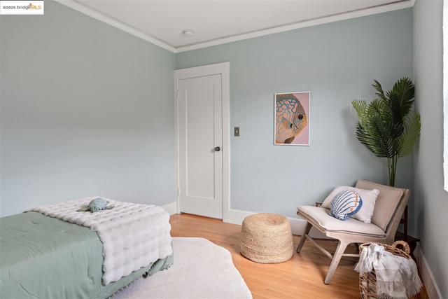 Bedroom with crown molding and light wood-type flooring
