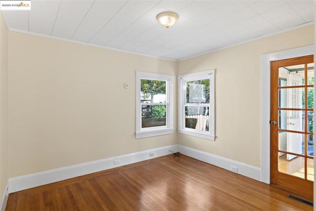 Spare room with crown molding and hardwood / wood-style flooring