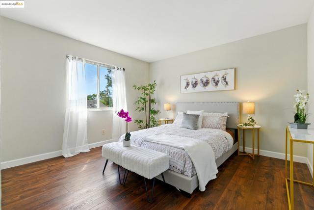 Bedroom with baseboards and hardwood / wood-style flooring