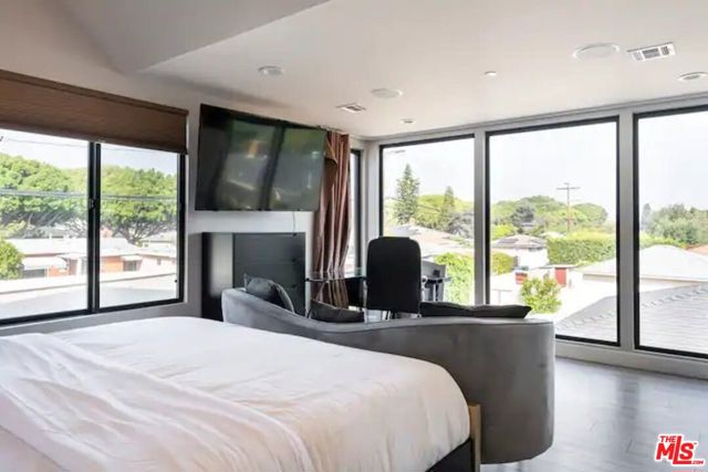 Bedroom #2 with a beautiful view, couch, and work space.
