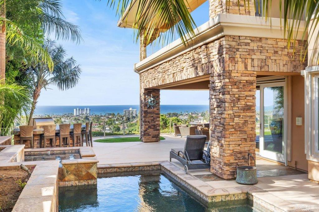 Panoramic views from one the most exclusive lots in Pacific Beach, where coastal luxury meets serene privacy. This custom built 5 bedroom 4.5 bath estate, rests atop an elevated and beautifully manicured 0.49 acre parcel, offering unobstructed 180 degree panoramic ocean views from every room.  Beyond the private gated entrance, you’ll find yourself in a secluded tropical oasis, meticulously designed for both elegance and relaxation. This expansive 4,546 sqft trophy home was built in 2004 and features a hydraulic elevator, dual zoned HVAC system, 3 car attached garage with epoxy floors, slate pool + spa with 3 cascading waterfall features, built in BBQ, custom firepit, and an owned sunrun solar system under Net Metering 1 offering  massive utility savings for the next owner. The property boasts a sophisticated yet functional layout with quality finishes and no wasted space, perfect for modern living. Downstairs features your main living areas including a 1 bedroom suite with an extra 1/2 bathroom for guests, and full laundry room. If stairs are a concern, then take your own private hydraulic elevator to the second floor which has 4 bedrooms, 3 full bathrooms, and 2 covered view decks. Wake up every morning to bay and ocean views from the comforts of your own bed in the grand primary retreat complete with its own fireplace, large walk-in closet, soaking tub, shower, powder seat, and enclosed toilet area. The living room consists of 20 foot cathedral ceilings with an immense stone fireplace, while the dining room attached features a custom painted ceiling to match the dining table. The gourmet kitchen is great for entertaining with its functional layout and flow into the family room and yard areas. The side yard is perfectly designed and landscaped to create a tropical feel with mature trees to complement the slate pool and spa with pebble tec finish and 3 cascading waterfall features. Don't miss your chance to own one of the best homes in San Diego.