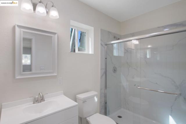 Full bathroom with vanity and a marble finish shower
