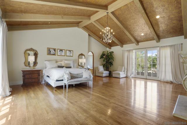 Retire to the enchanting master bedroom suite with coffered ceilings, beautiful hand carved fireplace, a coffee bar and refrigerator, and more.