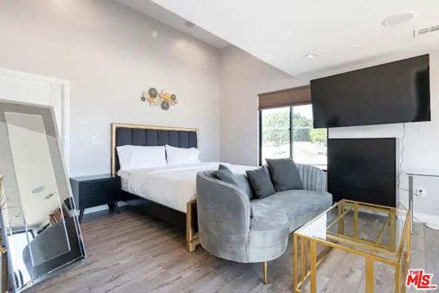 Bedroom # 2 with a king sized bed, walk-in closet, and en suite bathroom
