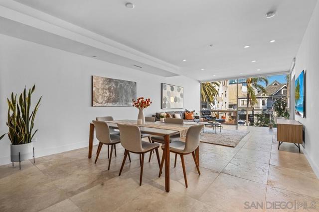 Inviting open concept formal dining area featuring cityscape views from the floor to ceiling windows.