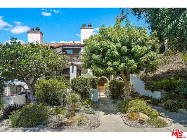 1816 Palisades Drive Pacific Palisades, California Idyllic location overlooking a private park with the mountains beyond. This wonderful, updated end unit is uniquely situated in the much sought after, Palisades Villas . With its own large private patio, surrounded by beautiful landscaping, this property is a retreat from the city, yet minutes to Sunset Blvd, PCH and the Palisades Village. Maple wood floors thru out, Custom shutters, double pane windows, new appliances, AC and furnace. Light filled, extra spacious living room with high beamed ceiling. Booklined den, and large eating area off the gourmet kitchen. Sun kissed landing with built in desk and work area. Gorgeous master bedroom with head on mountain views and remodeled bathroom. Generous ensuite second bedroom. Finished garage with many built in cabinets. Pool, Spa, Tennis Courts and Exercise Room are all included.