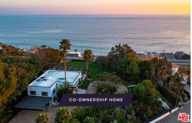 New co-ownership opportunity: Own 1/8 of this professionally managed, turnkey home. Cool, casual and contemporary, this 3-bedroom, 3-bathroom Malibu retreat offers ocean views and indoor/outdoor living at its best. Pocketing Fleetwood glass doors connect the living room with a massive deck. Set against an ocean backdrop, the deck features a BBQ area, fireplace, two fire pits and a spa. A few steps down from the deck is a large grassy lawn and garden, with stunning Pacific vistas. The sleek kitchen has plenty of counter space, high-end appliances and casual island dining. Just steps away is a more formal dining area facing the garden. Folding glass doors in the generous primary suite lead to the deck and ocean views. The crisp en suite bathroom has a relaxing soaking tub and tiled shower. Two more bedrooms and a bathroom complete the main floor. The lower level consists of a laundry room and a studio suite with a three-quarter bathroom. The home, with private beach rights, comes fully furnished and professionally decorated.