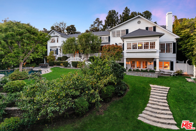 9588 LIME ORCHARD Road Beverly Hills, California Nestled in the gated community of Hidden Valley sits this classic East Coast Traditional with incredible craftsmanship & attention to detail. Beautiful oak flooring flows throughout with hand crafted mouldings and French doors that open to the backyard. The main level has elegant & functional living spaces, including a cook's kitchen, breakfast nook with built-in banquet, formal dining room, wet bar & a beautiful mahogany paneled office off of the formal living room. Four additional bedrooms reside on the top floor, each with en-suite bathrooms and their own walk-in closets. The master suite features bay windows, dual-walk in closets & a gorgeous bathroom with freestanding tub & picture window that looks out to the backyard. A covered, spacious outdoor area also overlooks the pool & grounds. The lower level includes a temperature controlled wine room, sauna, gym & guest bedroom. This home is located in one of Beverly Hills' most sought after communities & is a timeless traditional.