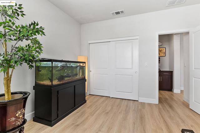 Bedroom with light wood-type flooring and a closet
