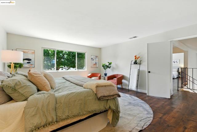 Bedroom with dark wood-style flooring
