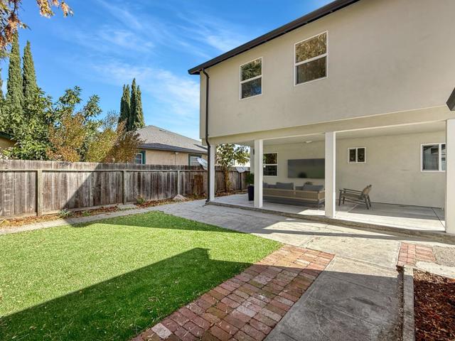 View Of Yard From Garage to Virtually Staged Backyard Patio Area