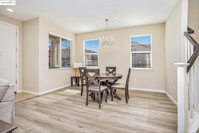 Dining space featuring light wood finished floors, a chandelier, and recessed lighting