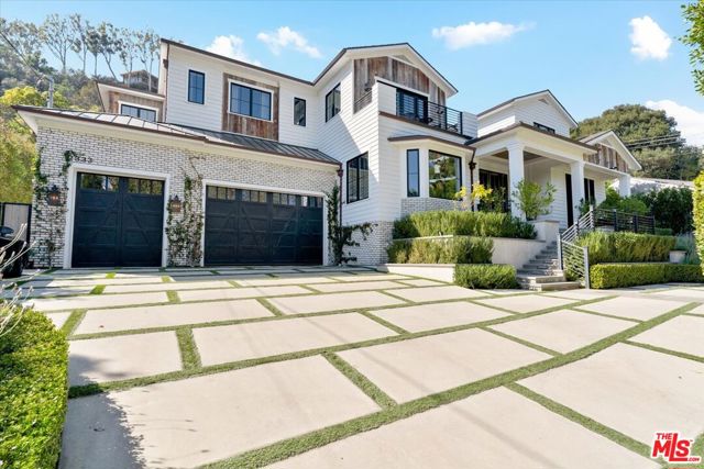 2333 MANDEVILLE CANYON Road Los Angeles, California Lower Mandeville Canyon Contemporary Farmhouse. This Newer Construction Luxury Gated Estate boasts quality craftsmanship and timeless on point design. Enter through large double doors into a dramatic open and airy center hall floor plan. French Oak floors and high ceilings throughout. Living room with fireplace opens to a library with built-in cabinetry and custom sliding barn doors. A Grand formal dining room connects to a double butlers pantry. State of the art chef's kitchen with large breakfast room opens to a grand family room with a modern wall of glass slider's that open to this spectacular back yard featuring a sparkling pool/ spa, BBQ and mature landscaping. 2 guest suites located on the main floor flank each side of the home and overlook the backyard. Dazzling powder room with lighted onyx vanity. An open staircase leads to the Primary suite with vaulted ceilings, fireplace, terrace overlooking backyard, steam shower, relaxing soaking tub, 2 large walk in closets, 3 guest suites and expansive family room loft. The fully finished lower level has a private movie theater, custom bar, gym room with steam room, game area, and a temperature controlled wine room / cellar with black metal french glass doors for viewing. This Smart home is fully equipped and has automated luxury window treatments throughout the home. This Estate has a large 3 car garage with direct entry, beautifully landscaped front yard with a circular driveway, mature privacy hedges and extra parking for guests.