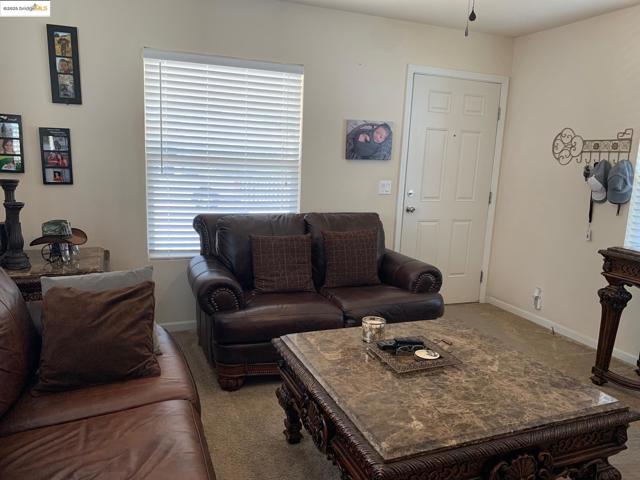 Carpeted living area with baseboards