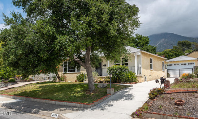 2943 Los Olivos Lane La Crescenta, California Set in the beautiful foothills of La Crescenta, this single-story Diamond in the Rough is ready for reimagining! Three bedrooms and two baths offer 1,536 sq ft of living space, with mountain views, bright spacious rooms and terrific layout. There is new carpeting throughout the house, with wood floors underneath. Large picture windows and lovely brick fireplace highlight the living room and dining area. Centrally located in the home is the kitchen, adjacent to the family room with glass sliders for easy indoor-outdoor flow for entertaining or outdoor living on the backyard patio. The primary bedroom is situated away from the other bedrooms and has its own ensuite bath. Two additional bedrooms with hall bath offer versatility for home office or guests. Convenient indoor laundry provides plenty of storage. The detached two-car garage holds a built-in workbench and oversized storage shelves, with options for use as a home gym or studio. There is ample space for parking or playing in the generous driveway. Convenient to parks, freeway access and award-winning La Crescenta schools, this property offers tremendous potential to customize and make it your own!