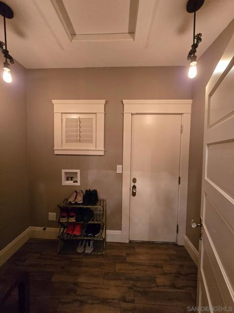 Foyer off the kitchen with door leading to backyard and garage