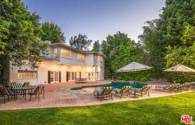 15475 Milldale Drive Los Angeles, California Located on a quiet, tree-lined cul-de-sac in coveted upper Bel Air, this elegant traditional home was exquisitely reimagined by Faye Resnick Design and masterfully designed for entertaining. Amenities abound in this offering: seven bedrooms (one currently being used as a gym), a theater, an office, a pool, a multi-purpose sports court for paddle tennis or pickle ball, a putting green, a large grassy lawn, and multiple areas for entertaining both indoors and out. French doors throughout create tremendous indoor and outdoor flow. A bright and airy chefs kitchen opens to a family room and is located right off of the sophisticated pub with large fireplace and wet bar. Upstairs are four of the seven bedrooms, including the voluminous master suite with dual showroom closets. Truly a rare find with this assortment of amenities and design.