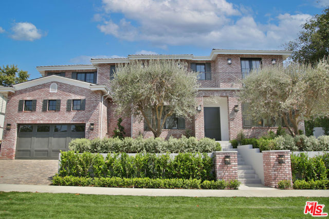 10001 Cheviot Drive Los Angeles, California An unrivaled Cheviot Hills residence on a sprawling nearly 10,300sqft+ corner lot in coveted Country Club Estates! Completed in 2021 with the finest of finishes, this immaculate traditional truly showcases masterful craftsmanship at every turn. The main floor foyer leads to a grand formal living room flooded with natural light, featuring a classic stone fireplace, which opens to the formal dining room with gorgeous coffered ceilings, impressive glass encased wine room and chic butlers pantry. The impeccable gourmet kitchen features state-of-the-art appliances, handcrafted glass embellished cabinetry, farmhouse sink and a tremendous waterfall edge, honed marble center island which leads to a warm family room with walls of glass and custom built-ins, opening to the lushly landscaped yard. The second story provides an opulent master suite boasting a lavish en-suite bath with glass-encased shower, soaking tub, dual vanities, envious walk in closet, private office and oversized balcony. Three additional spacious guest rooms with gorgeous en-suite bathrooms complete the upstairs living quarters. With soaring ceilings, the impeccable finished basement includes an expansive family room, generous sized private suite with full bath, perfectly appointed home theater, private gym and bonus playroom providing a one-of-a-kind entertaining space, unlike any other. The expansive and intimately private outdoor living space is complete with stone patios, classic brick fireplace, outdoor kitchen & spectacular oversized rolling lawn!