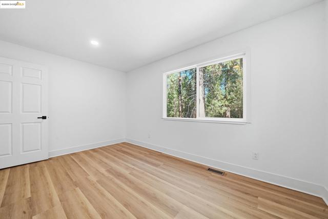Unfurnished room featuring light wood-style flooring and recessed lighting