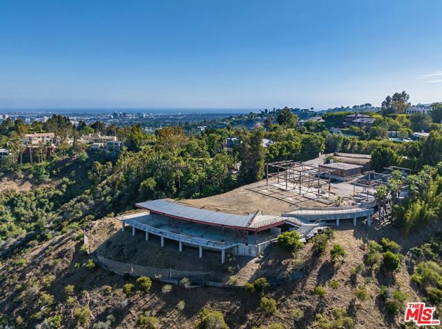 World-Class Estate Site. Over 4.5 acre promontory with panoramic views. One of the finest lots available in Bel Air. Sited down a long private driveway. Jetliner views from Downtown to the Ocean. Incredible flat land with partial steel framing in place. Inquire for additional details. Shown only to prequalified Buyers.