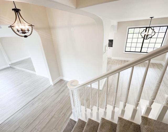 Stair case with red wood railing