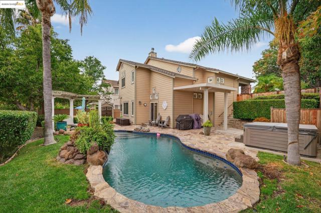 View of swimming pool with a hot tub, a fenced backyard, a patio area, a pergola, and grilling area