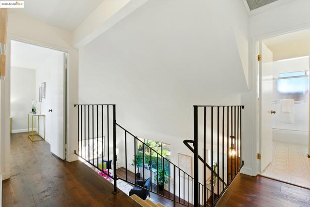 Hall with an upstairs landing and wood finished floors