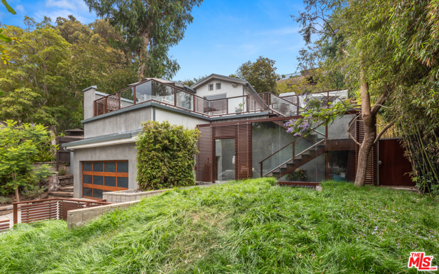 744 Kingman Avenue Santa Monica, California Contemporary, serene retreat in the highly coveted Santa Monica canyon. This sensational 2 bedroom, 3 bathroom home is surrounded by secluding landscaping with treetop views. The large grassy front yard features an added water feature that takes you out of Santa Monica and into your own personal resort. An oversized deck invites you into the home, featuring sitting areas for guests and a barbecue for unforgettable get togethers. You will be stunned by the contemporary details of this home abounding with natural light throughout. Entering into the kitchen, one is greeted with top of the line appliances including a Wolf oven, stove top and more. Greenery pokes throughout with large windows showcasing the trees and plants the property sits on. Earth is a central theme throughout the home, bringing prominence to the outside life beyond the property walls. Make yourself at home in this intimate, beautiful sanctuary minutes from the beach. The ideal and perfectly balanced Santa Monica lifestyle. Including a short walk to Canyon Charter elementary school.