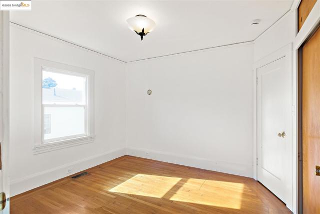 Spare room with light wood-type flooring and baseboards