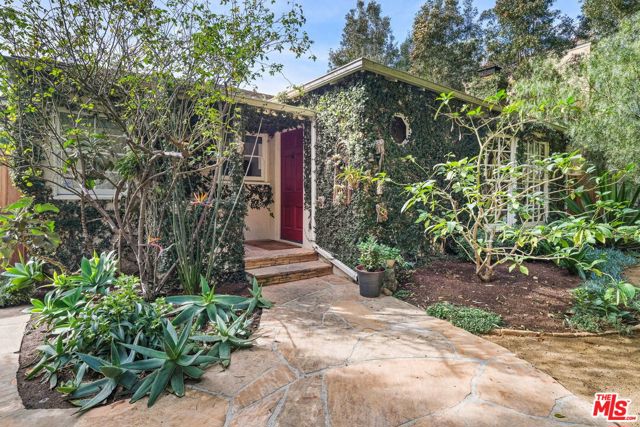 2444 Cloverfield Boulevard Santa Monica, California This lovingly appointed home will be your island of calm - gleaming hardwood floors, a wood burning fireplace in the living room, a warm and inviting cook's kitchen - the heart of the home - complimented by the vintage O'Keefe & Merritt range. Both bedrooms are steeped in sunshine, and the baths lovingly renovated. Stepping outside you'll be absolutely delighted to find an en plein air living room, al fresco dining room, and exquisite gardens. A gurgling reflecting pond, home to a dozen koi, always soothes the soul. A detached guest house is perfect for a music studio, Zoom school, or potter's wheel. Privately tucked behind the garage-cum-workshop is a hot tub with views of the stars. There might even be room for a chicken coop. It's just perfect.