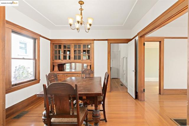 Dining space featuring a chandelier and light wood-type flooring