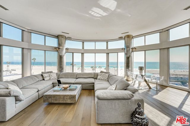 Live Your Best Beach Life! 180 degree jaw-dropping ocean view. 12 foot ceilings in the main living area. The ocean is your living art. Watch sailboats drift by, dolphins play, and the sun rise and set from this iconic condo with unparalleled views. Enjoy the Santa Monica Pier Ferris wheel lit up at night, and a coastline of fireworks in July. Have a drink at the light-up bar or out on the deck. Walk to the beach or a nearby restaurant.  All Three bedrooms have ensuite baths. There's a half bath for main level guests. Primary bedroom also has a head-on 180 degree ocean view with two walk-in closets. The kitchen features top of the line Miele/Viking appliances. It also has a 150 bottle Viking wine cooler with three independent cooling zones. There are easy to care for Quartz counters throughout. Downstairs has a large laundry room with sink and plenty of storage cabinets. One bedroom on the main level has been turned into a media room with seven leather reclining chairs. Can easily be returned to a bedroom/office. Lutron solar blinds are on every window and can be controlled with a remote or a phone app. The primary bathroom has a Bain Ultra heated-back hydro-jetted bathtub with chromatherapy and aromatherapy. The wet bar is made of handmade glass that lights up. This unit has three  parking spots with two electric car chargers. The pool area is in the process of having a multi-million dollar makeover which will be completed in May.