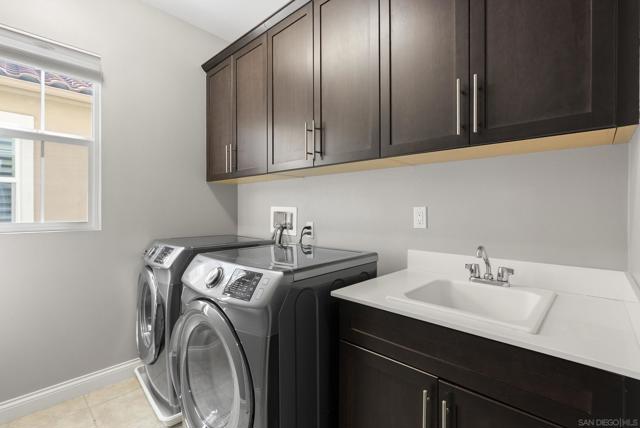 Upstairs with LG washer and dryer, cabinets and sink