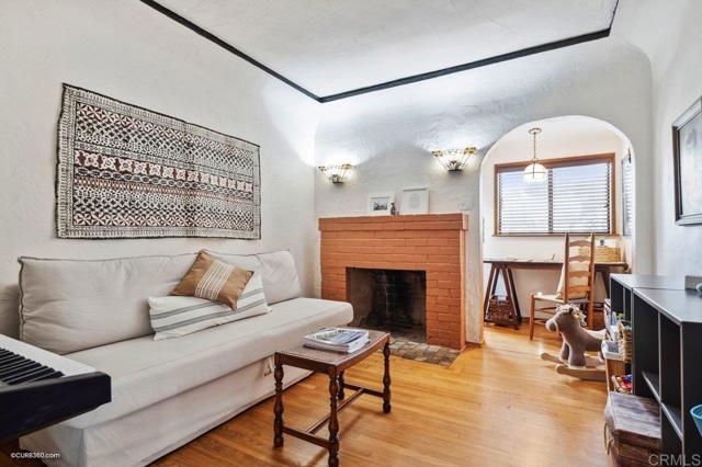 Entry level den/fourth bedroom with original decorative fireplace