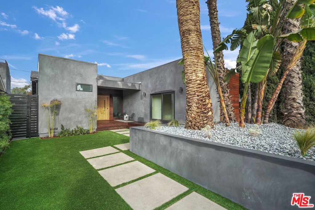 Presenting 981 Lake Street, a meticulously rebuilt modern haven located in the heart of iconic Venice. This single-story home offers coveted Westside living, situated within minutes of Rose Ave, Abbot Kinney, and Lincoln Blvd, providing easy access to local shops, restaurants, and more. Boasting 4 bedrooms and 4 bathrooms, this residence features a junior ADU with a full bath and kitchenette, making it a versatile space for guests or extended family. No detail has been overlooked in the design of this home, with engineered hardwood floors, extensive built-ins, and soaring 14-ft ceilings creating an inviting atmosphere. The open main space seamlessly connects the living room, dining area, and chef's kitchen. Sophisticated and functional, the kitchen boasts a large waterfall island, Wolf six-burner range, wine fridge, porcelain counters, and ample cabinetry. Accordion glass doors provide a seamless indoor/outdoor flow to the backyard, complete with a BBQ and fridge for al fresco dining and entertaining. The primary suite is a retreat of its own, featuring a walk-in closet and a spa-like bath with a large glass shower, soaker tub, and dual sink vanity. Additional highlights include well-appointed guest rooms, two gas fireplaces, surround sound speakers in main living plus the primary suite, recessed lighting, a gated entry leading to a beautifully landscaped front yard with an IPE deck, and a gated driveway for added security. Experience the epitome of Venice living in this thoughtfully crafted and recently rebuilt residence.
