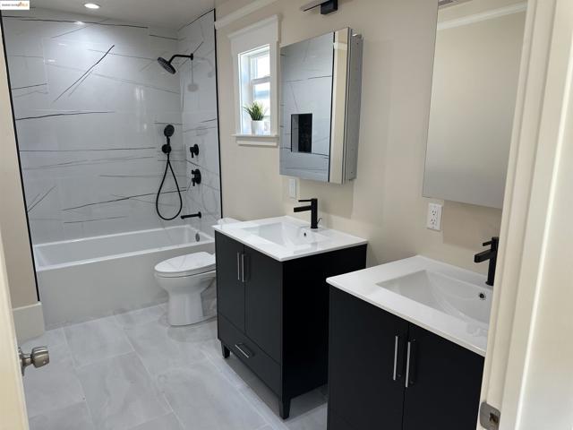 Full bathroom with vanity, shower / washtub combination, and tile patterned floors