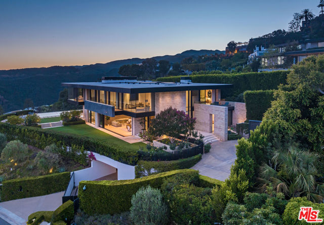 The Perfect Blend of modern architecture, panoramic views, A+ Location and every conceivable amenity. Designed by Paul McClean and built by Tyler Construction to the highest standards. Sited on nearly 2/3 acre promontory with wrap around views from Will Rogers Park, the Pacific Ocean to Downtown Los Angeles. The location is unparalleled in the Palisades Riviera. The centerpiece of this architectural jewel is a 3-story waterfall/courtyard with walls of glass on 3 sides. Envisioned for entertaining on a grand scale, the living room opens to main lawn and the dining room soars with double height ceilings. Gourmet Kitchen and family room adjacent to large infinity-edge pool and covered dining - all with spectacular views to the West. Upstairs, 5 major bedrooms suites, including a primary that rivals the finest hotels in the world. 7 bedrooms in total, makes for an incredible family estate. The Lower level includes game room with bar, wine cellar, state-of-the-art cinema and gym with sauna. Car museum with turntable completes this most special offering. One of only a few modern view estates in the Riviera, iconic in every way. Shown only to prequalified buyers.