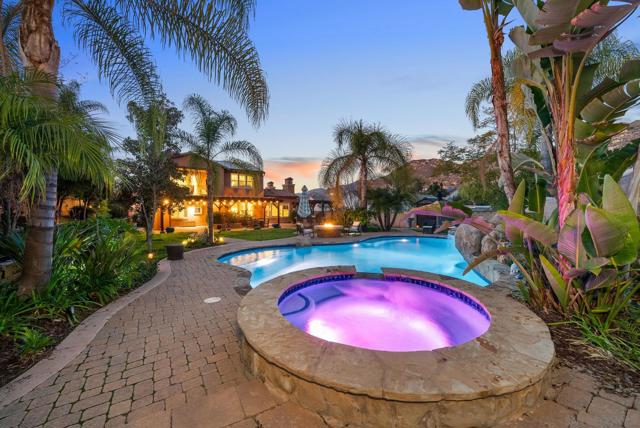 Jacuzzi and pool view facing back of home