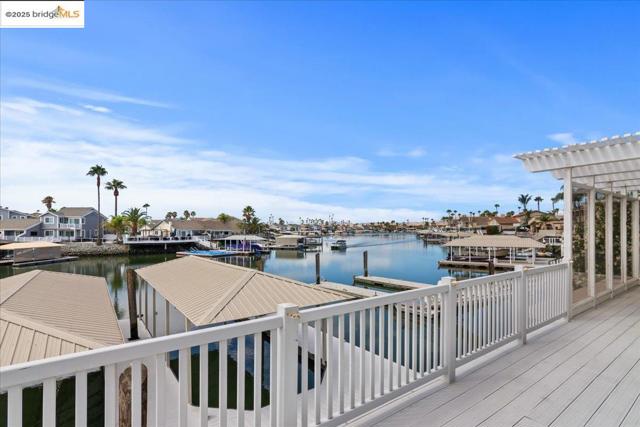 Dock featuring a water view, a residential view, and a pergola