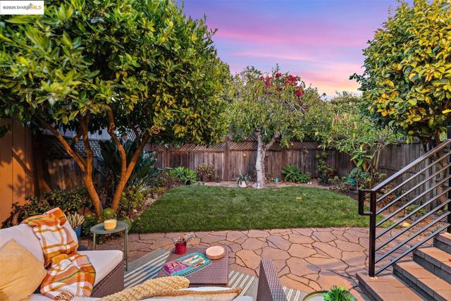 Fenced backyard featuring a patio area and stairway
