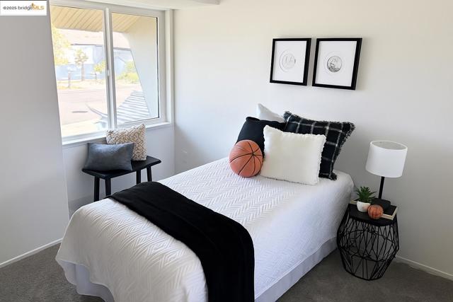 Carpeted bedroom featuring baseboards